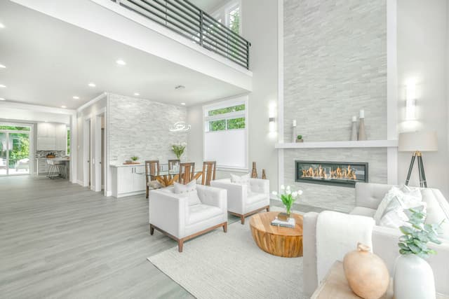 Bright open-plan living room with fireplace in a remodeled Greater Houston home